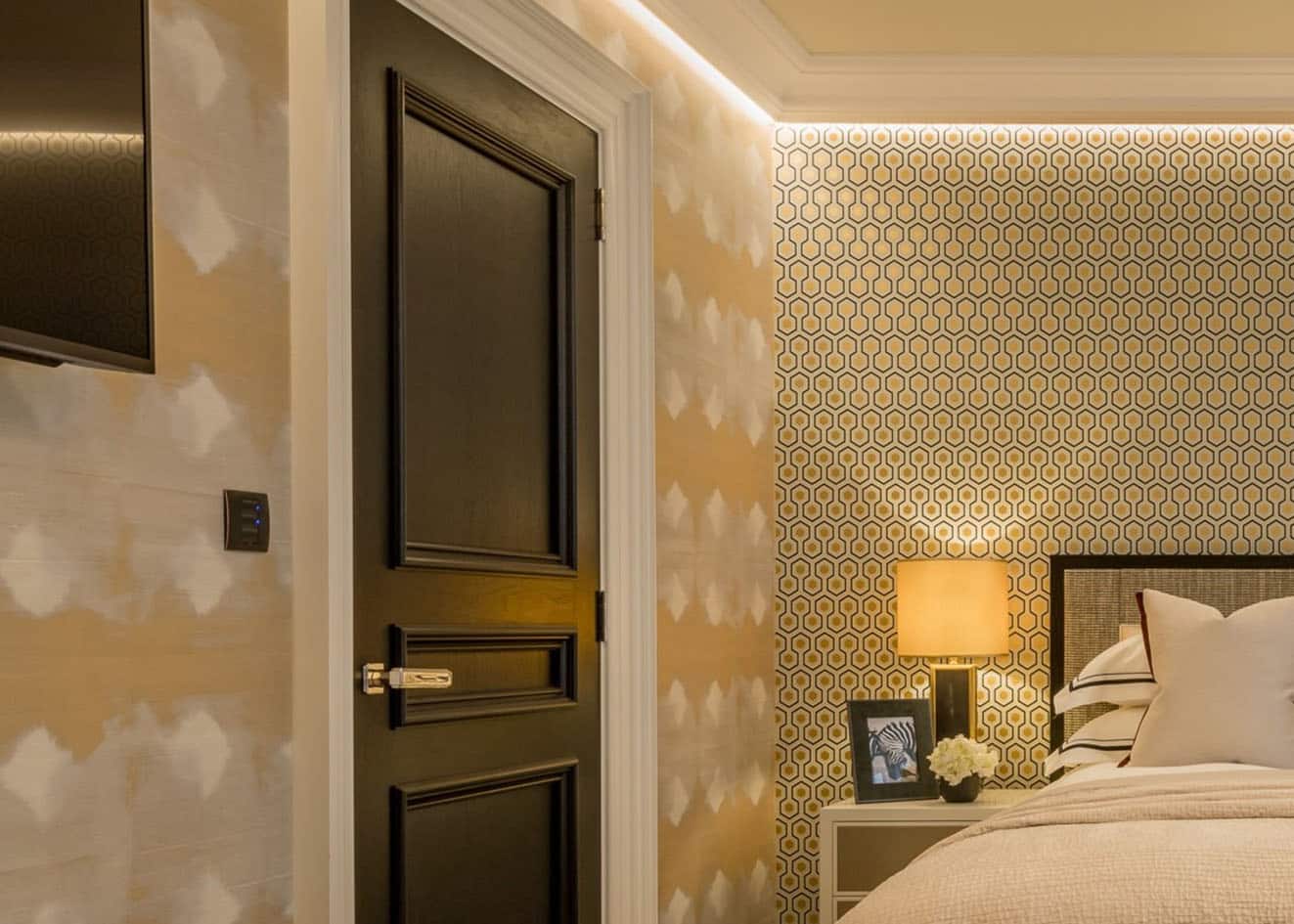 Two patterned Elitis wallpapers combination in yellow tones installed in a bedroom.