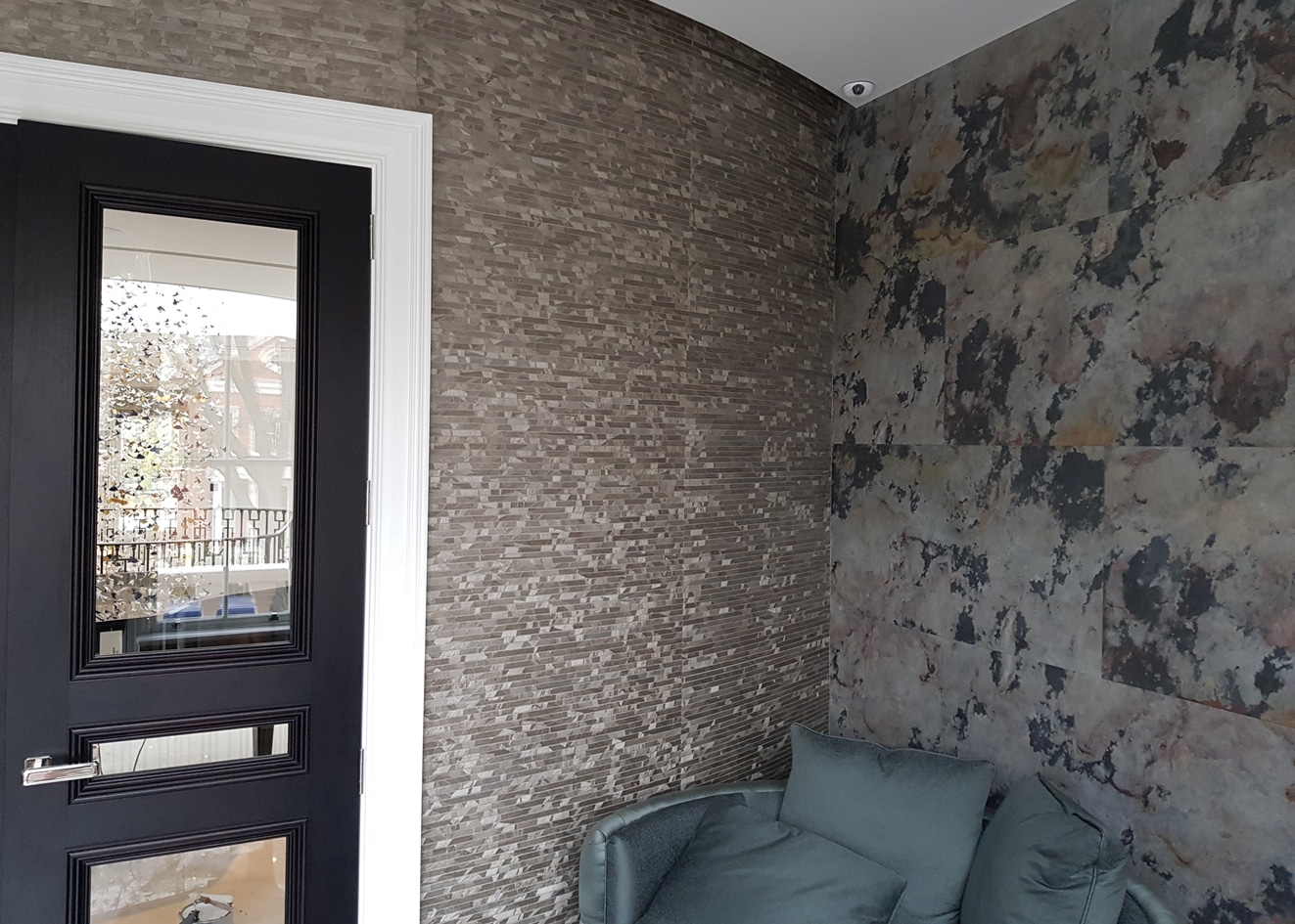 Silver Altfield London wallcovering on the left side and Phillip Jeffries Slate Tiles on the right.