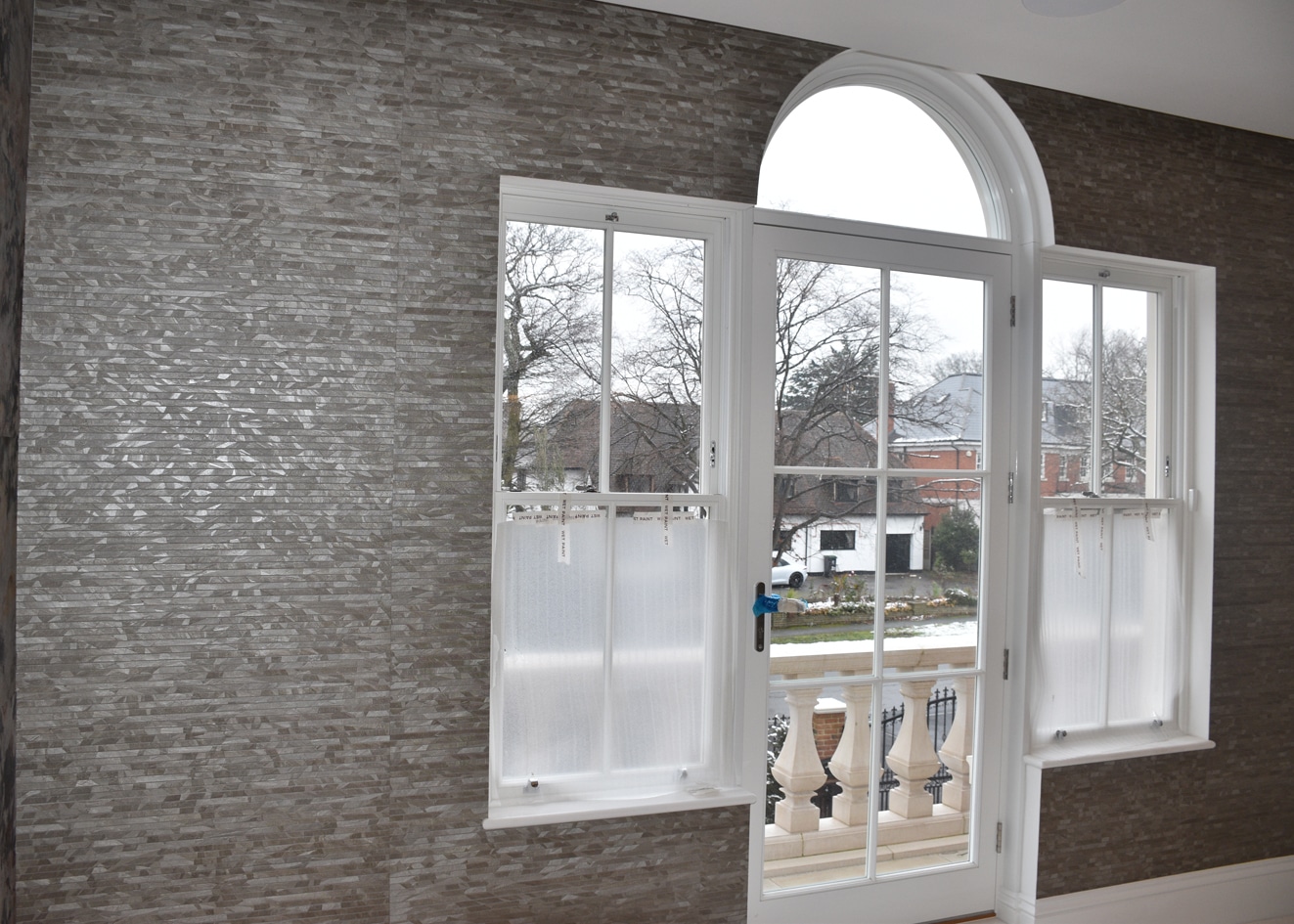 Altfield London wallcovering in silver next to a window.