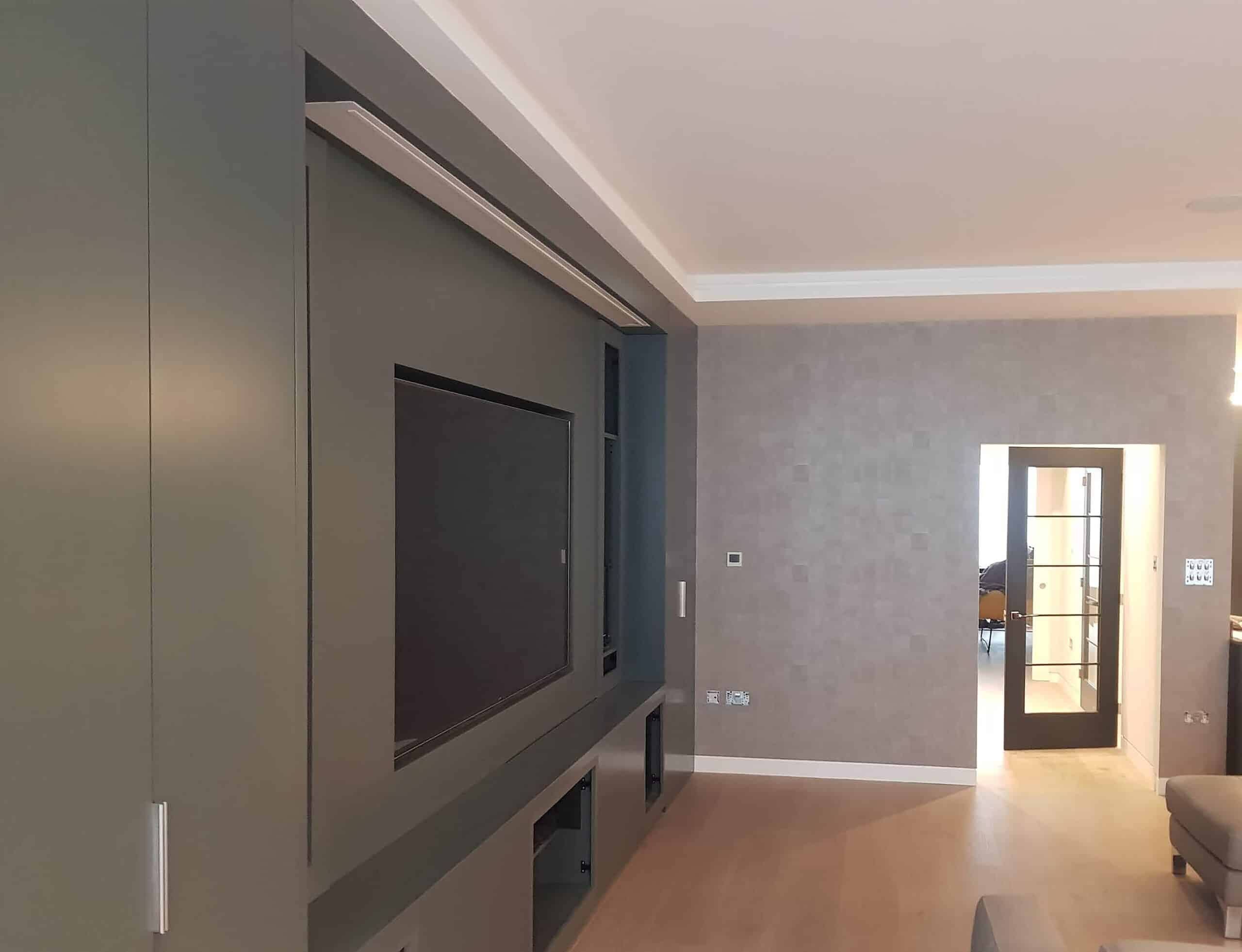 Armani Casa Designer wallpaper professionally installed by Bluespec Decorating Limited wallpaper hangers. There is wall tv unit on left in dark grey.