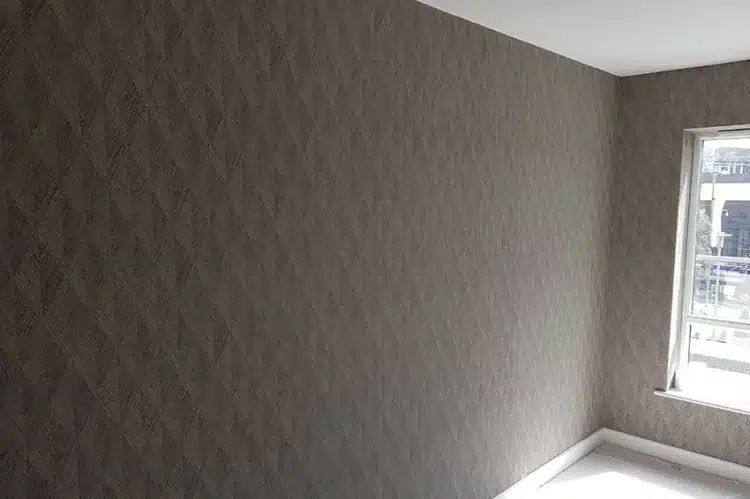 Fabric wallpaper hanging by Bluespec Decorating Limited wallpaper hangers, London.
