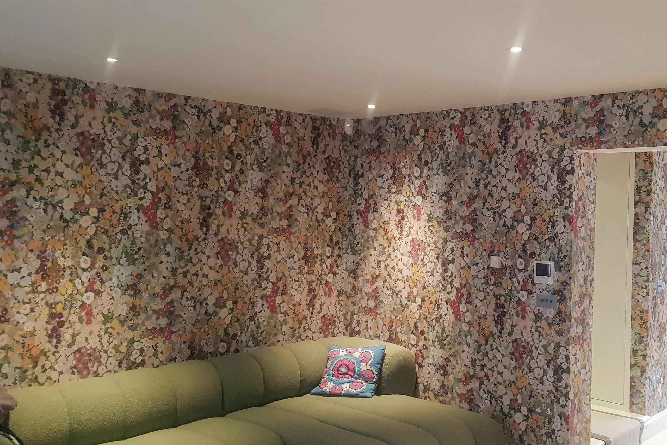 House of Hackney floral wallpaper installed in an open plan living room.