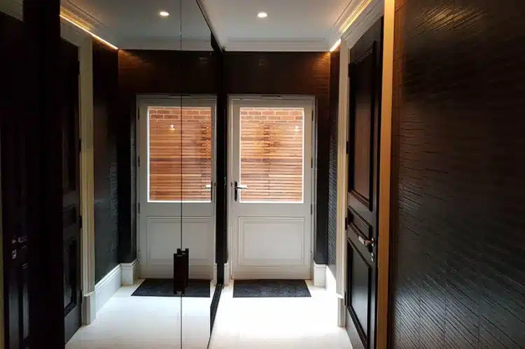 Leather wallpaper specialist installation in a hallway , London.
