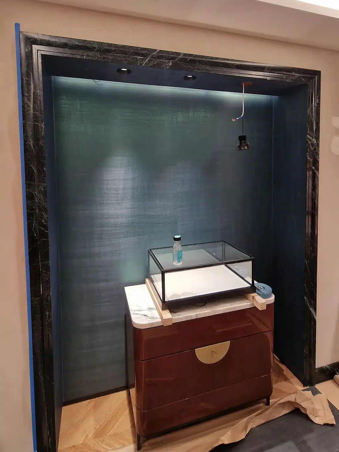 Silk wallcovering in blue installed in a jewellery shop in London by Bluespec Decorating Limited wallpaper hangers.