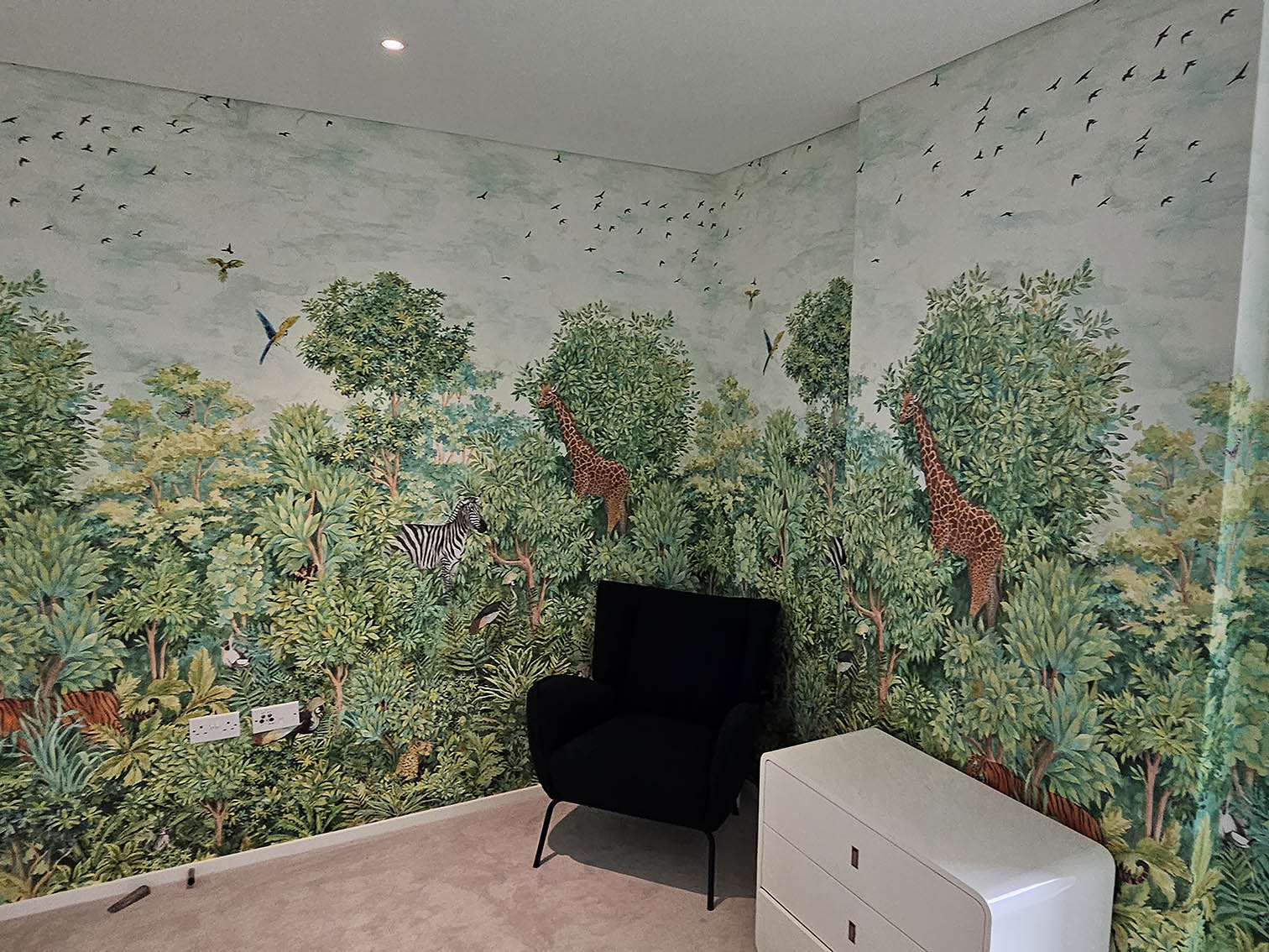 Digitally printed wallpaper installation in kids bedroom green plants, trees, animals and birds by Bluespec Decorating Limited.