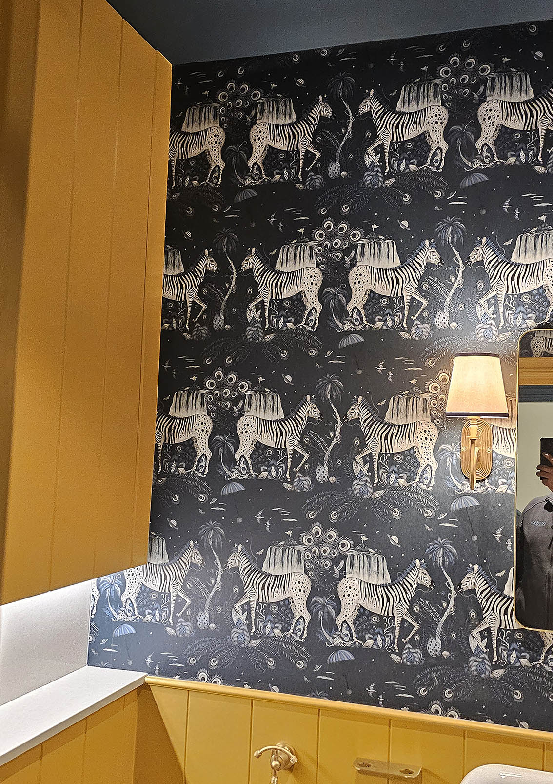 Professional wallpaper installation of zebras wallpaper in a bathroom.