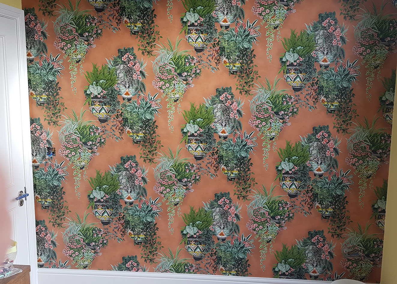 Feature wall wallpaper hanging. Colourful pattern.
