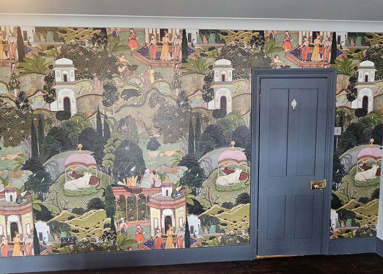 MINDTHEGAP made to measure bright and colourful with trees and buildings Rajasthan style wallpaper installed by Bluespec Decorating wallpaper hangers.