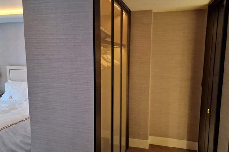 Tektura Bohemia wallcovering installation in Mayfair London. Wallpaper is installed on wall next to a mirrored wardrobe in a bedroom.