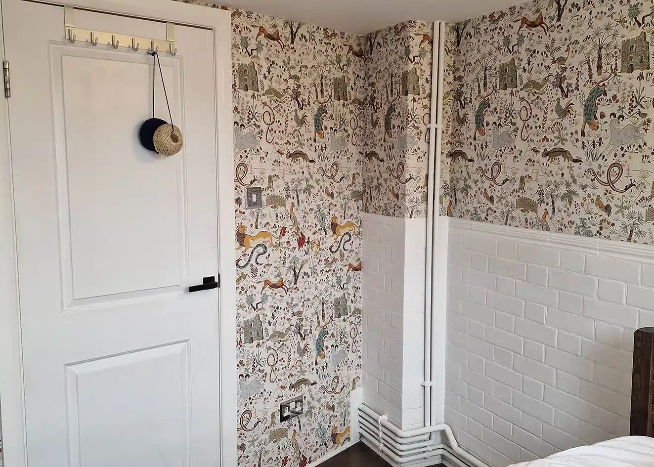 House of Hackney designers wallpaper installation in a bedroom.