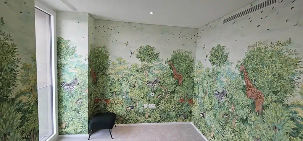 Kids bespoke wallpaper with green trees and animals.