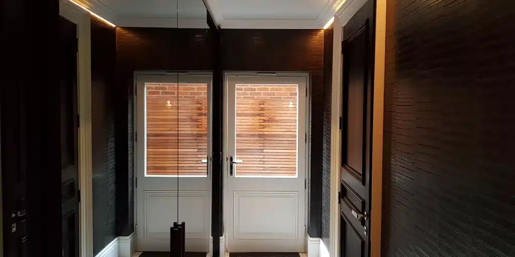 Designers luxury wallpaper with leather effect specialists installation in an entrance.