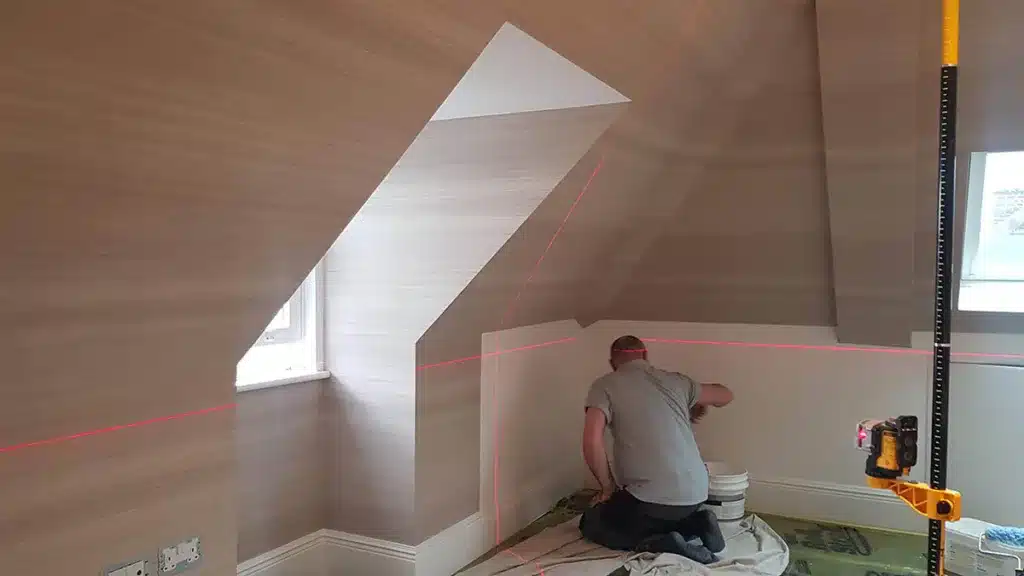 Wallpaper hanger using laser to install wallpaper.