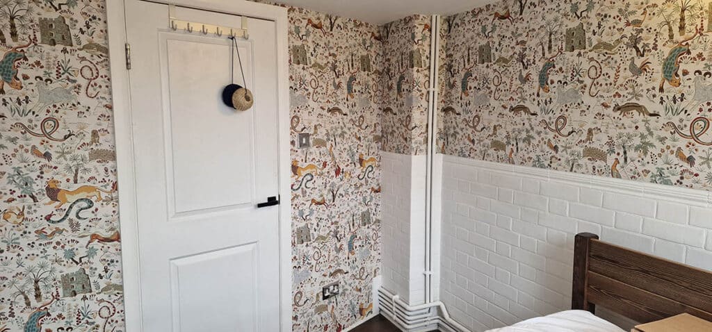 House of Hackney wallpaper installed in a bedroom.