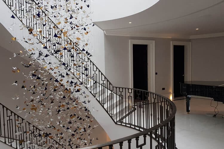 Luxury staircase and a chandelier hanging from the ceiling.