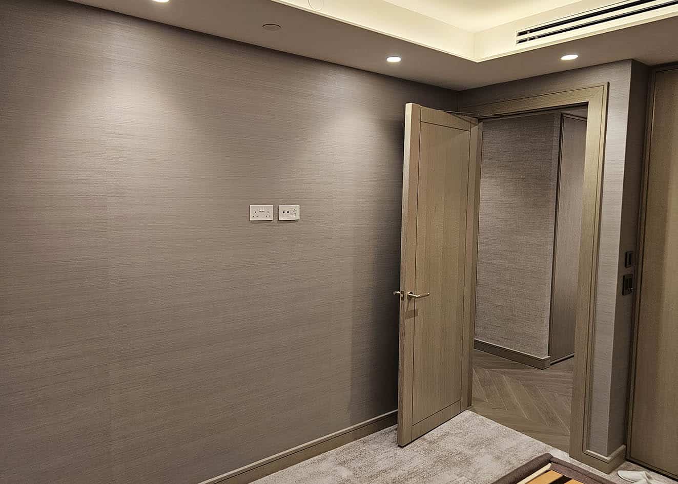 Wallpaper hangers install Arte textured wallpaper bedroom Swiss Cottage London luxury flat