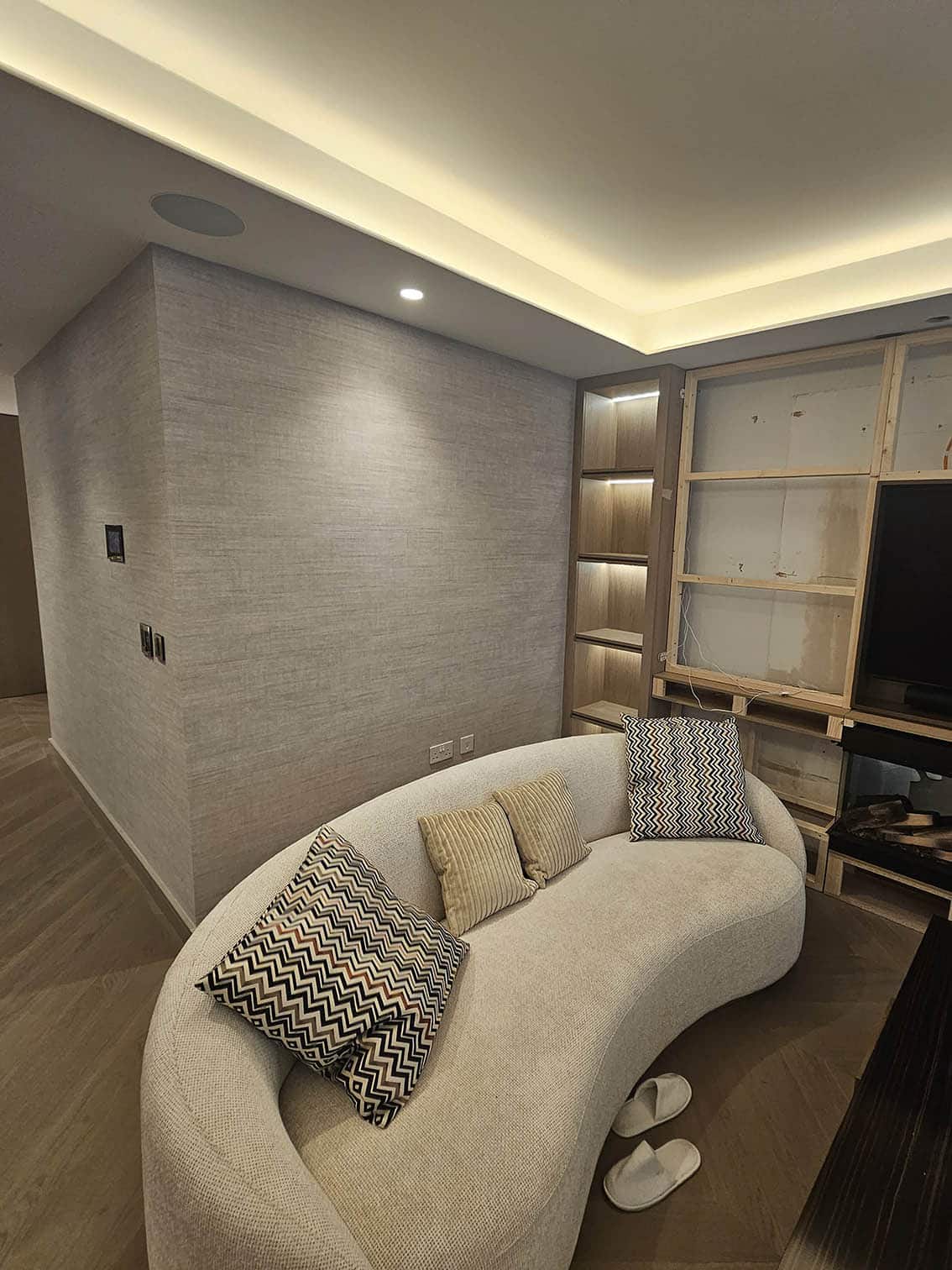 Wallpaper installation living room Swiss Cottage - Bluespec Decorating Limited professional wallpaper hangers London , white sofa.