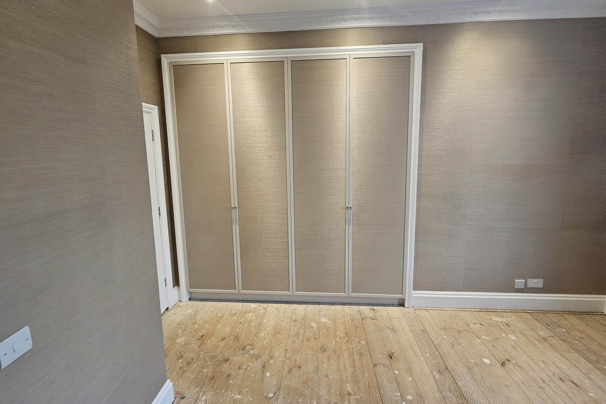 Wallpaper-wardrobe-doors-and-walls Wallpaper installed on wardrobe doors and walls in Notting Hill, London by Bluespec wallpaper hangers.