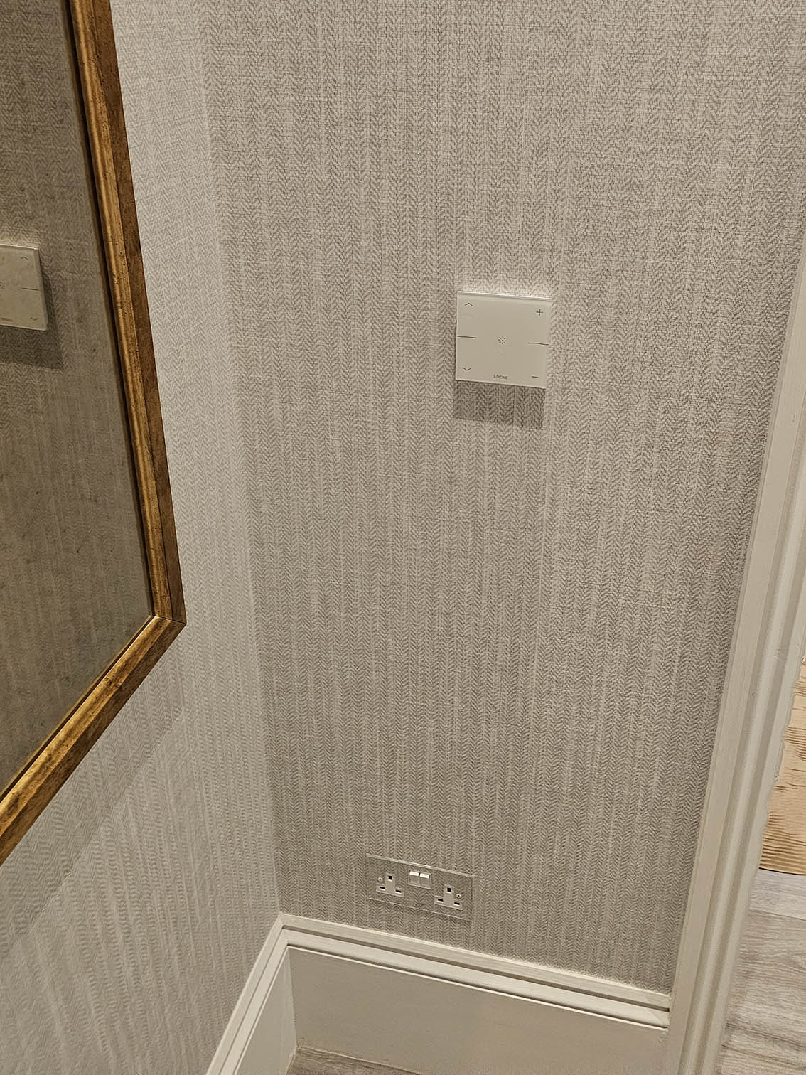 clear-socket-wallpapering Wallpaper installation around clear socket. The wallpaper is installed by Bluespec Decorating Limited.