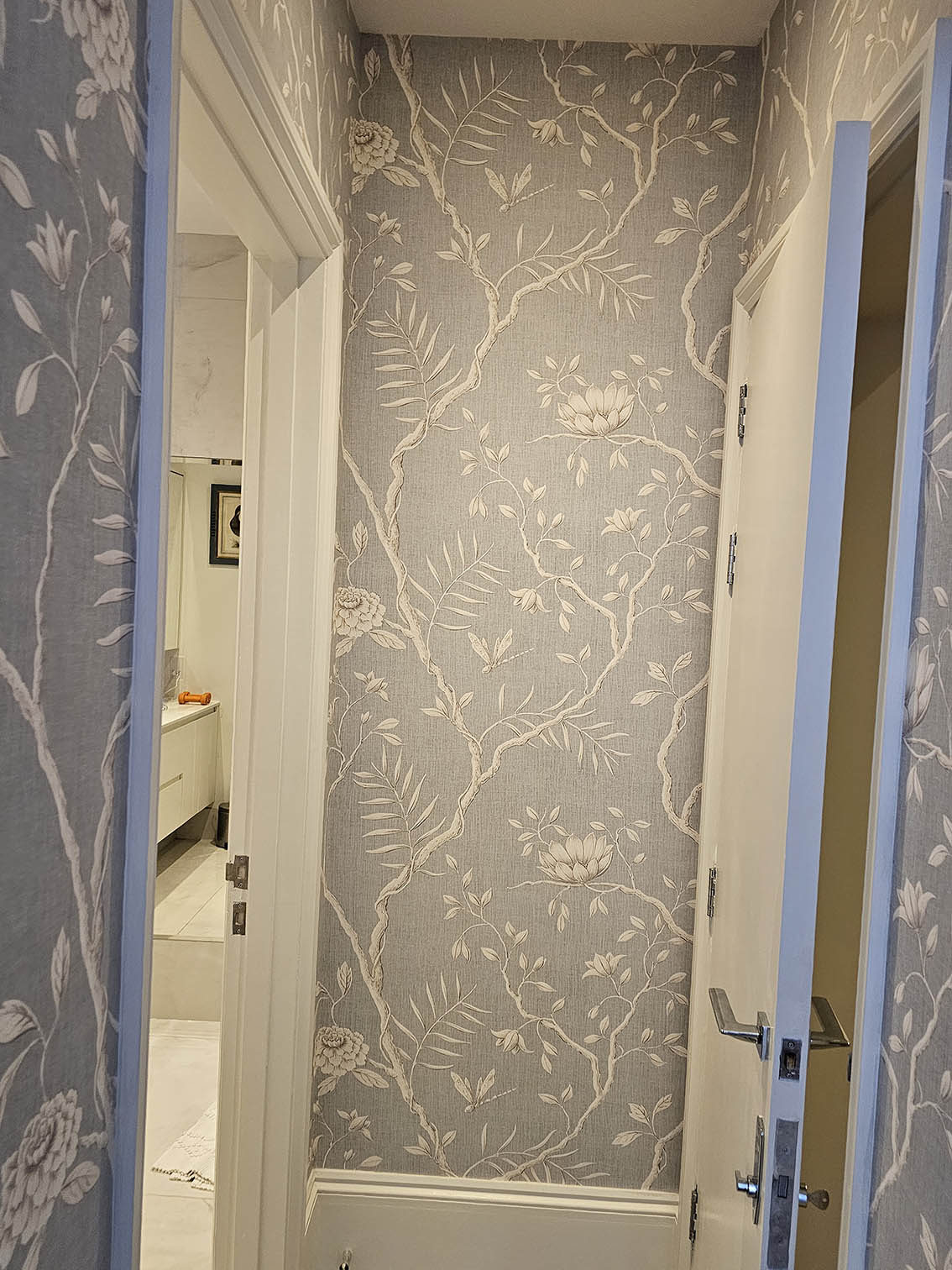 flowers-pattern-wallpaper-hanging-W11 Chinoiserie wallpaper professionally installed next to a bedroom wallpapered in the same wallpaper.