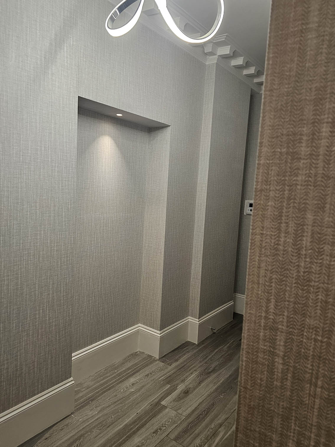 wallpapering-niches Wallpaper installed in a hallway in niches and on a wall by Bluespec wallpaper hangers in Notting Hill, London.